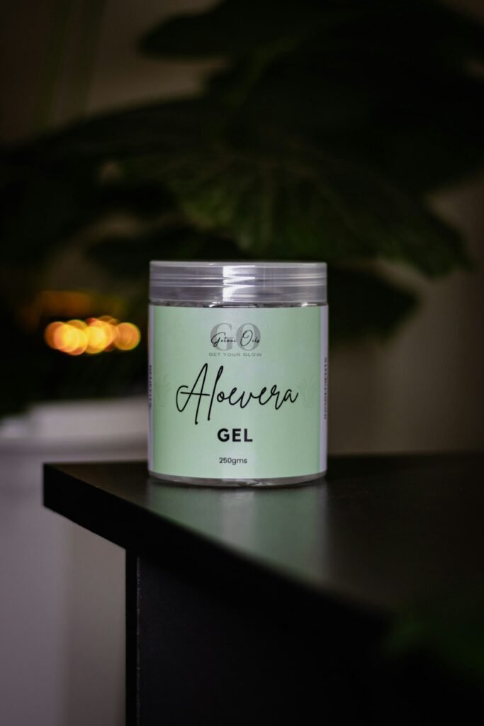 Aloe vera leaf and gel pump bottle on marble