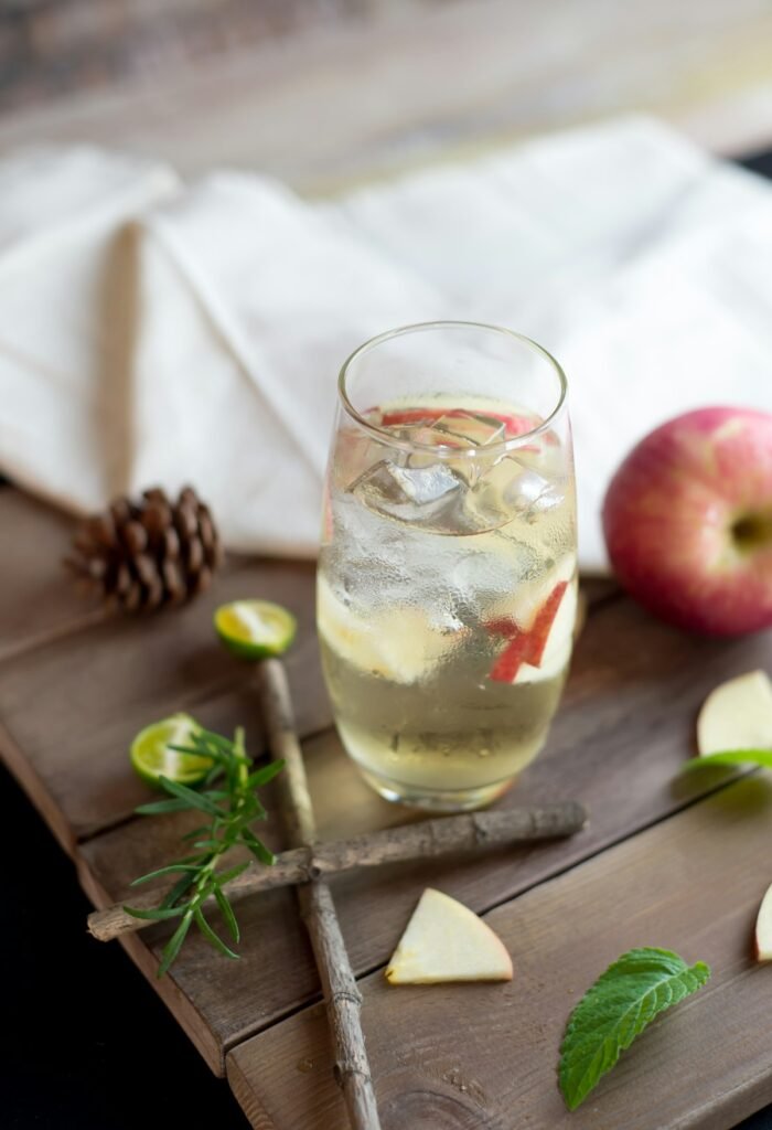 Bottle of apple cider vinegar with fresh apples